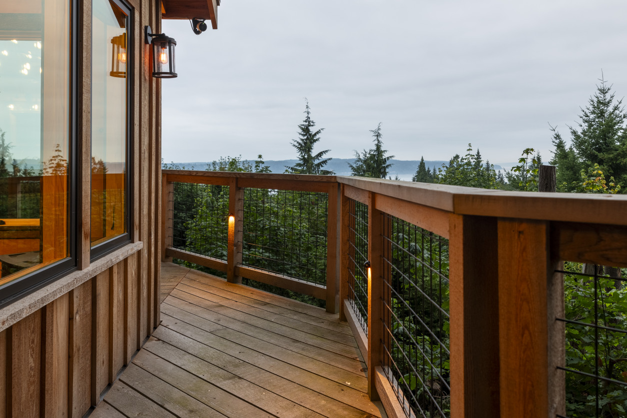 Exterior deck railing with integrated low-voltage lighting overlooking Puget Sound from a hillside home in Edmonds, Washington.