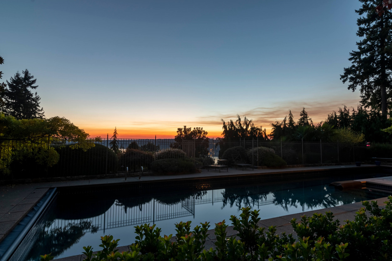 Sunset horizon over pool at Sammamish estate. Before picture of outdoor lighting.