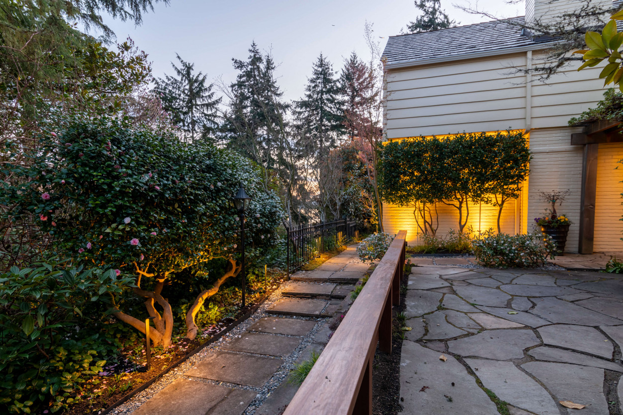 Front entry path lighting and uplit landscape greenery with 2700K lights in Magnolia neighborhood.